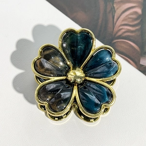 Detailed close-up of marble resin flower petals with elegant gold metal edges and center