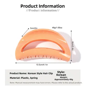 Detailed view of orange-pink crescent hair claw with dimensions and spring mechanism