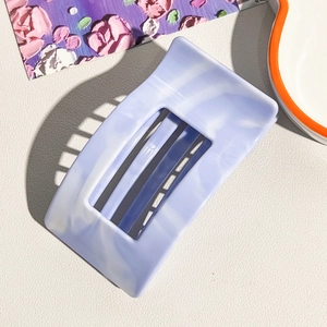 Detail of light purple marble pattern rectangular hair claw clip with a hollow design