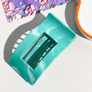 Detailed close-up of large mint green marble hair claw clip with soft matte finish