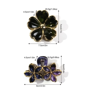 Gold-rimmed flower hair claw clips with green and purple resin petals for thick hair