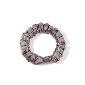 Elegant metallic grey silk scrunchie with soft satin luster and elastic pleated texture
