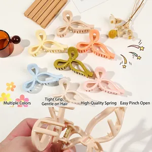 Set of colorful matte bow hair claws in pastel tones for elegant French hair styling