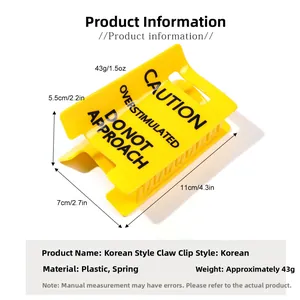 Detailed view of yellow hair claw clip showing 11x7cm dimensions and caution sign design
