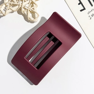 Macro view of burgundy rectangle matte hair claw clip with hollow structure