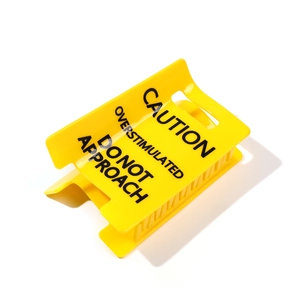 Caution Overstimulated sign hair claw clip in yellow with bold black warning text