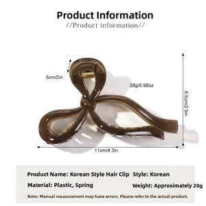 Detail view of brown bow hair claw clip showing 11cm length and 6.5cm height dimensions