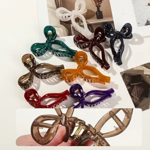 Elegant oversized ribbon bow hair claws in various translucent colors for women