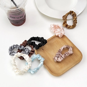 Elegant satin pleated scrunchies set in various colors for stylish ponytails and buns