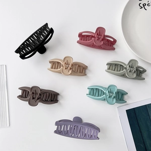 Macro view of assorted matte Morandi color mermaid tail hair claws on a white surface