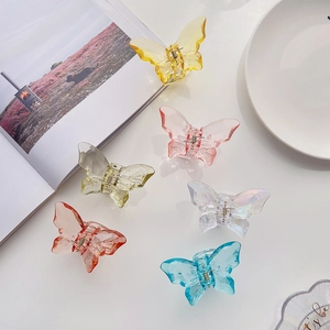 Detail of colorful butterfly hair claws in translucent acrylic with a faceted gemstone look