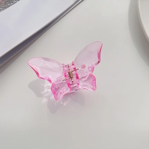 Detail of pink translucent butterfly hair claw clip with elegant 3D textured carving