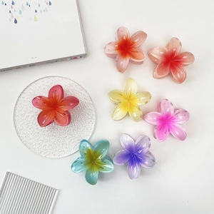 Colorful summer plumeria flower hair claws in a variety of vibrant gradient resin colors
