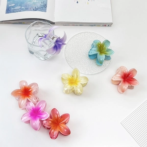Colorful Plumeria flower hair claws in vibrant purple and pink for summer styling