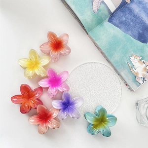 Detailed top view of seven colorful resin flower hair claws in various vibrant summer hues