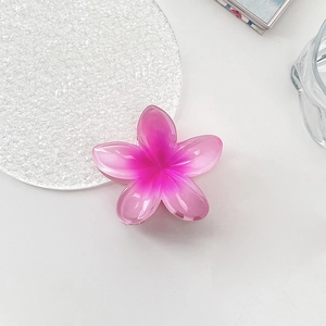 Detailed macro view of pink gradient resin flower hair claw clip with elegant gloss finish