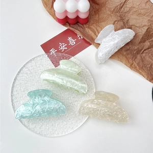 Detailed set of four acrylic hair claws with elegant marble and water ripple textures