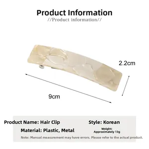 Detail view of 9cm cream marble acetate hair clip showing smooth texture and spring mechanism
