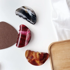 Close-up of assorted marble texture acetate hair claws in various elegant patterns