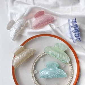 Detailed set of six marble-patterned acetate hair claws in pastel macaron colors