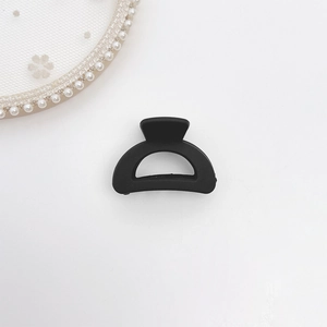 Detail view of the matte black half-round mini hair claw clip for high ponytail styling