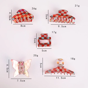 Detail showing five red checkerboard acetate hair clips with exact sizes and weights