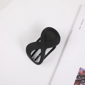 Close-up of matte black figure-eight hair claw clip with a secure hollow-out grip design