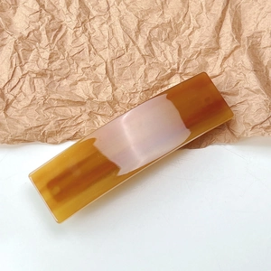 Macro shot of French acetate rectangular hair clip in amber tortoiseshell pattern