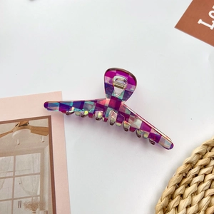 Detail of holographic purple checkered hair claw clip with durable metal spring
