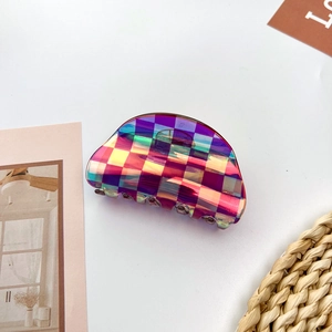 Macro detail of iridescent checkered pattern on a sturdy acetate hair claw clip