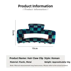 Detailed view of checkboard hair claw with 10x5cm dimensions and blue-green pattern