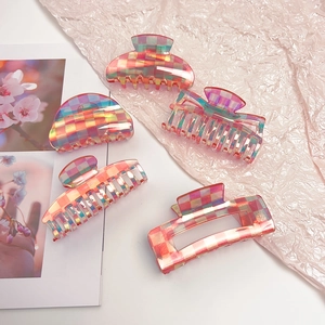 Detailed set of five pink checkered acetate hair claws in various geometric shapes