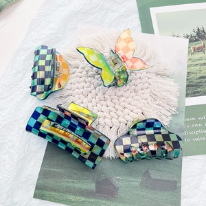 Set of four checkered acetate hair claws with iridescent finish for vintage hairstyles