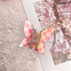Detail view of pink checkerboard butterfly claw clip with iridescent laser finish