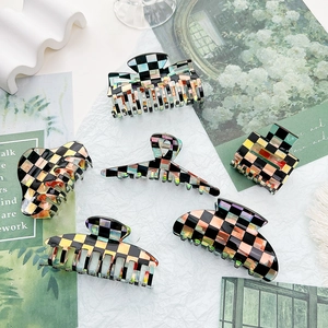 Minimalist black checkered acetate claw clips for hair styling in various shapes and sizes