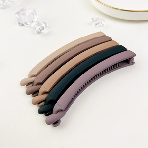 Close-up of matte banana hair clips set with non-slip teeth in earthy neutral tones