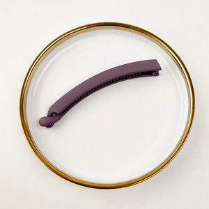 Close-up of matte purple banana clip with non-slip teeth for secure ponytail styling