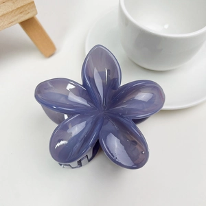 Vue détaillée d'une pince à cheveux hibiscus violette avec fini brillant et ressort solide