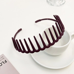 Close-up of matte dark purple toothed headband with long comb teeth for secure hair grip