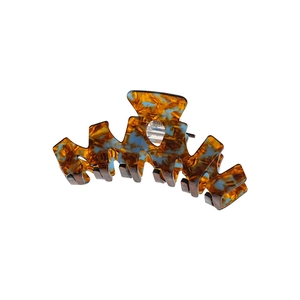Large tortoiseshell hair claw clip with unique blue marble resin finish in geometric shape