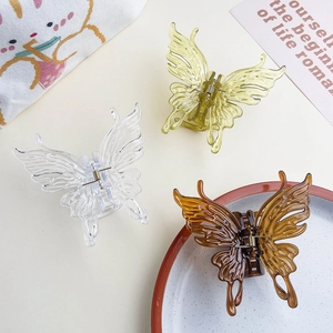Trois pinces à cheveux papillon translucides en couleurs clair, citron vert et ambre