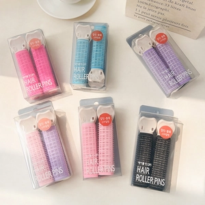 Close-up of colorful hair roller clips in 2-piece sets for voluminous bangs styling