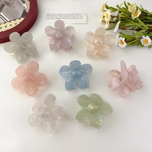 Detail view of eight colorful floral hair claws in high-quality acrylic resin material