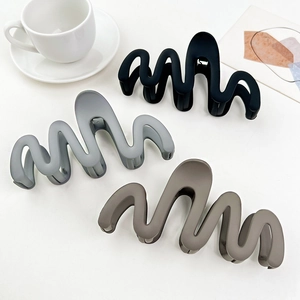 Three-piece set of wave-shaped matte hair claws in black, light grey, and tan colors