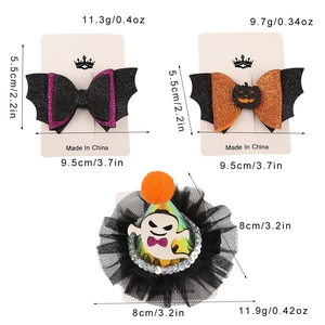 Detailed view of Halloween hair clips featuring glitter bows and a mesh ghost accessory