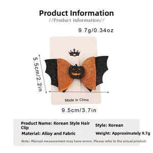 Detail view of Halloween glittery bat wings and pumpkin hair clip with size measurements