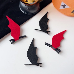 Detail of red and black bat wing hair clips made of felt for Halloween parties