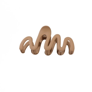 Matte light brown wavy hair claw clip with minimalist curved design on white background