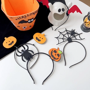 Close-up of Halloween headband set with pumpkin spider motifs and felt candy bucket