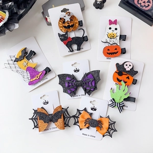 Detail of Halloween hair clips featuring pumpkin, ghost and bat designs with sequins